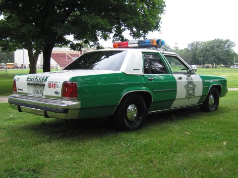 1991 Ford Crown Victoria - This 1991 Ford Crown Victoria Sheriff car is seen from a three-quarter front view, parked on grass.