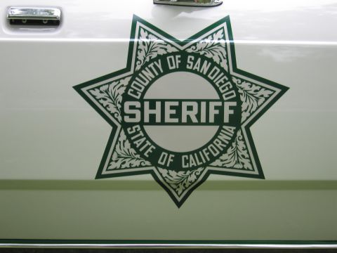 1991 Ford Crown Victoria - The San Diego County Sheriff's Department emblem is displayed on the side of a white vehicle.