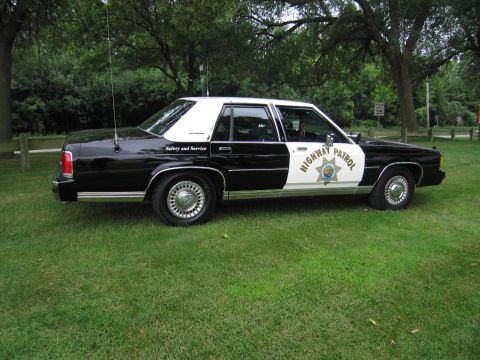 1991 Ford Crown Victoria - This 1991 Ford Crown Victoria is marked as a highway patrol vehicle and is parked on a grassy area.
