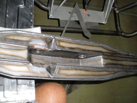 1995 Ford Bronco - Close-up view of a welded metal component, possibly from a vehicle's suspension or frame, showing intricate welding and bolt holes.