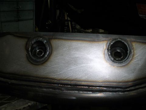 1995 Ford Bronco - Close-up of a welded metal component with visible bolt holes and texture.