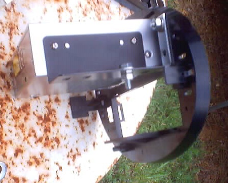 1999 Ford Taurus - A close-up view of a metal assembly with a black plate and a circular rim, likely a vehicle component.