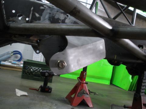 1995 Ford Bronco - Custom suspension bracket attached to a vehicle's frame, supported by a jack stand.