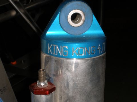 1995 Ford Bronco - A close-up view of a King Kong 4.0 shock absorber, highlighting its blue mounting bracket and silver body.