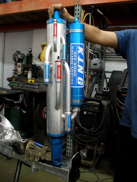 1995 Ford Bronco - Two King Off-Road Racing Shocks are shown, blue reservoirs and silver bodies with adjustable compression and rebound.
