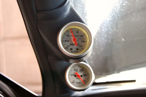 1985 Mercury Grand Marquis - Two gauges, one for boost and one for fuel, are visible inside the vehicle's cabin.