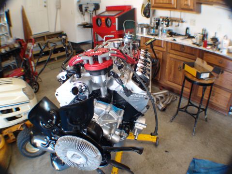 1996 Ford Bronco - Engine on a stand in a garage setting, with various tools and equipment visible in the background.