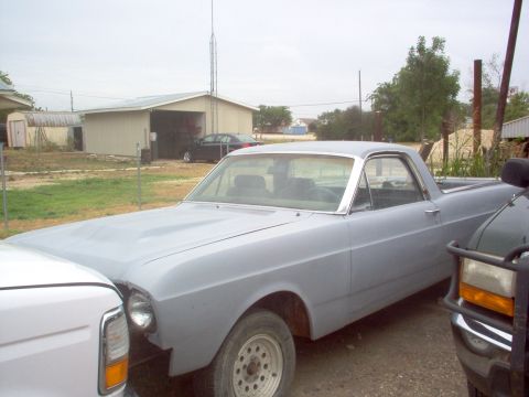 1966 Ford Ranchero - A 1966 Ford Ranchero, prepped for paint, sits in a yard with other vehicles.