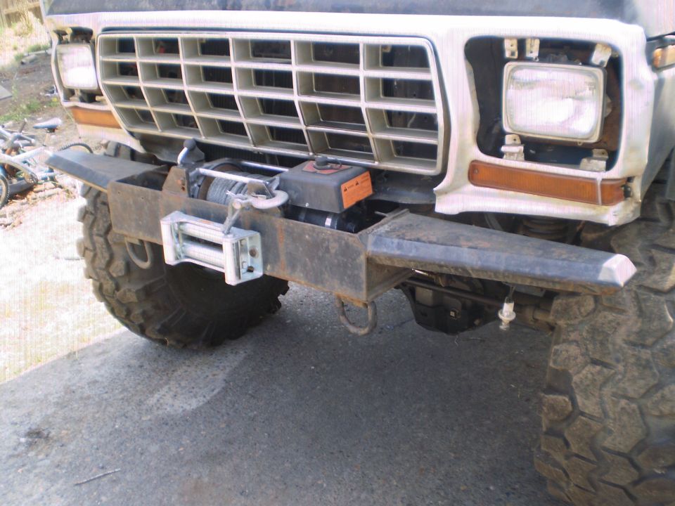 White late-70s Ford front end with homemade steel winch bumper and mud-terrain tires