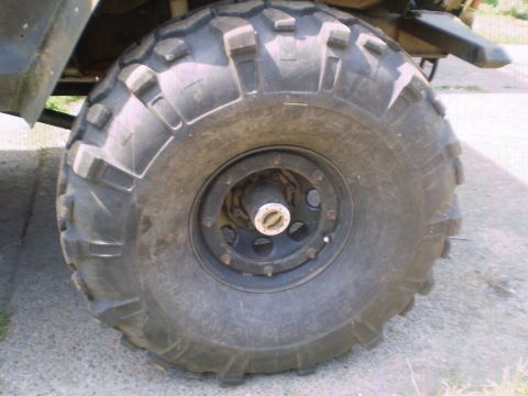 1978 Ford Bronco - This image focuses on a single, off-road tire and its wheel assembly, with a portion of the vehicle's frame visible.