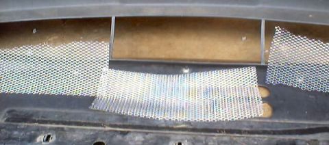 1999 Ford Taurus - Mesh grille inserts are visible on the front of a vehicle.