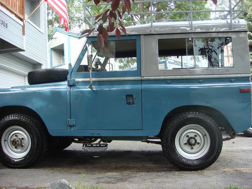 Side view of blue 1972 Land Rover Land Rover with grey hardtop and roof rack