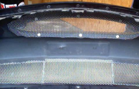 1999 Ford Taurus - Close-up view of a custom mesh grille with a hexagonal pattern.