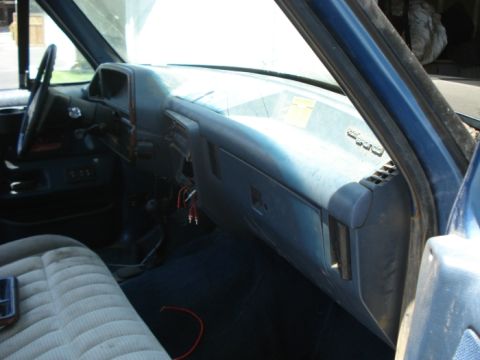 1990 Ford Bronco - The interior dashboard of a 1990 Ford Bronco is visible from the passenger side.