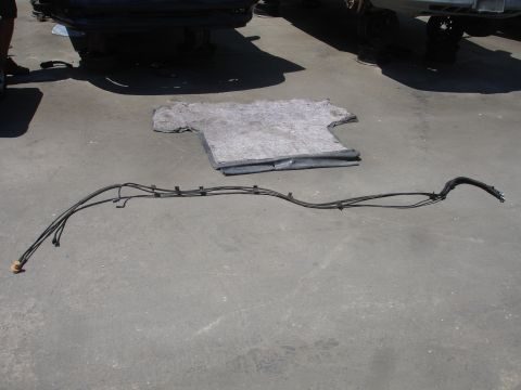 1991 Ford Taurus - Fuel lines are shown on the ground, separate from the vehicle.