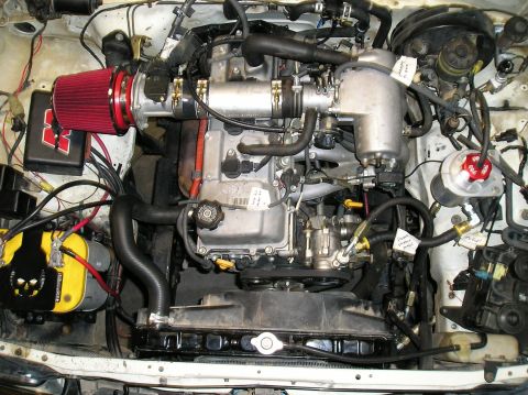 1986 Toyota Hilux - Engine bay details showing aftermarket modifications and a custom air intake system.