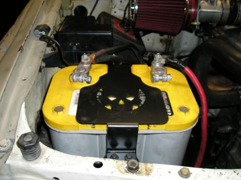 1986 Toyota Hilux - Close-up of a vehicle's engine bay, focusing on the battery and air intake system.