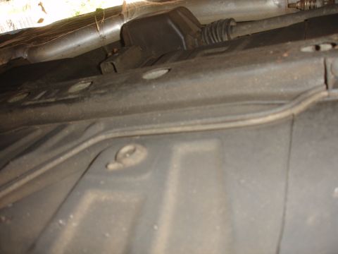 1991 Ford Taurus - Underside view of a vehicle, showing exhaust pipes and suspension components.