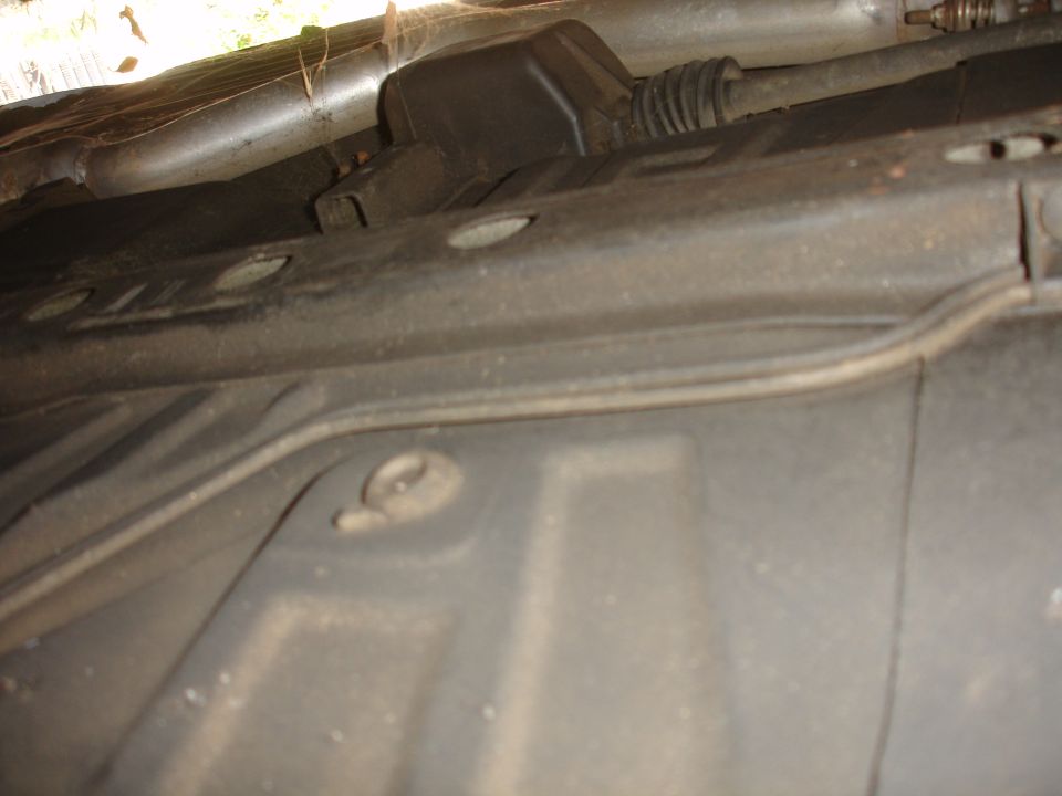 Underside view of vehicle with exhaust pipe and suspension