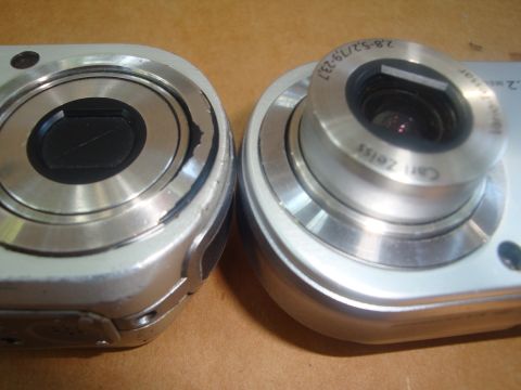 1993 Ford Taurus - A close-up view shows the lenses of two digital cameras, with one Carl Zeiss optics and zoom range markings.