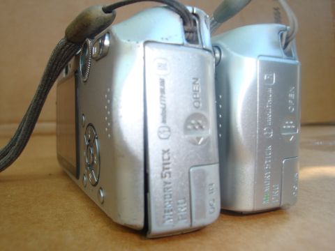 1993 Ford Taurus - Two digital cameras are shown from the side, revealing their ports and branding.