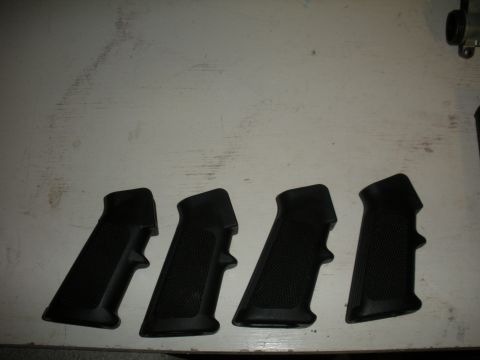 1996 Ford Bronco - Four black pistol grips are laid out on a white surface, with a website logo visible at the bottom right.