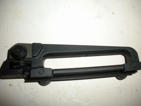 1996 Ford Bronco - Close-up of a black plastic carrying handle with visible metal parts and wheels.