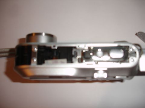 1993 Ford Taurus - The internal workings of a digital camera are exposed, revealing its intricate electronic and mechanical parts.