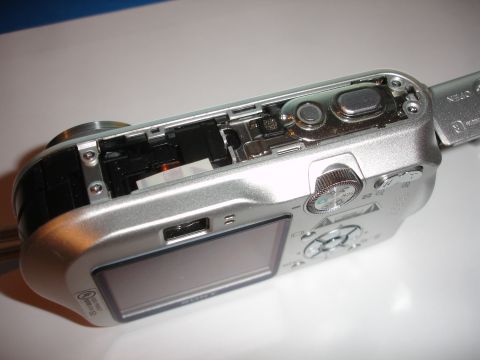 1993 Ford Taurus - A disassembled digital camera reveals its internal circuitry and a USB port, with the lens mount visible on the left.