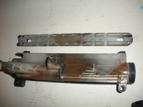 1996 Ford Bronco - AR-15 upper receiver and handguard, painted with camouflage pattern.