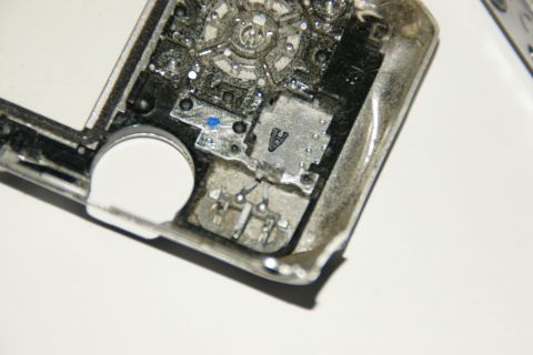 1993 Ford Taurus - Close-up view of the internal components of a car key fob, revealing intricate circuitry and a small battery.
