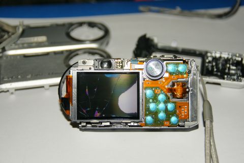 1993 Ford Taurus - A disassembled Sony digital camera shows its internal components and a cracked LCD screen.
