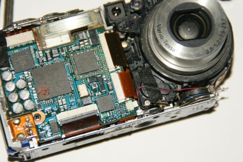 1993 Ford Taurus - The internal components of a digital camera are exposed, revealing intricate circuitry and electronic parts.