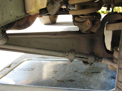 1986 Ford Bronco - Underside view of a Ford Bronco's suspension system, focusing on a stamped metal component.