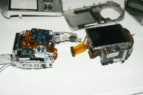 1993 Ford Taurus - Internal components of a Sony digital camera are laid out on a white surface.