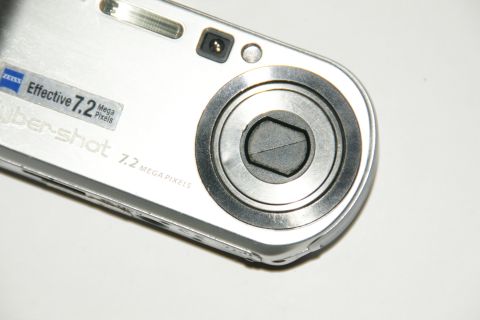 1993 Ford Taurus - A close-up view of a silver Sony Cyber-shot digital camera, highlighting its lens and branding.