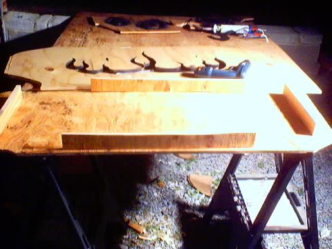 1999 Ford Taurus - Wooden cutouts are laid out on a workbench, possibly for a project.