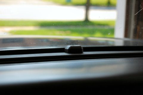 1985 Mercury Grand Marquis - Interior view of a car's dashboard and windshield, with a small sensor visible.
