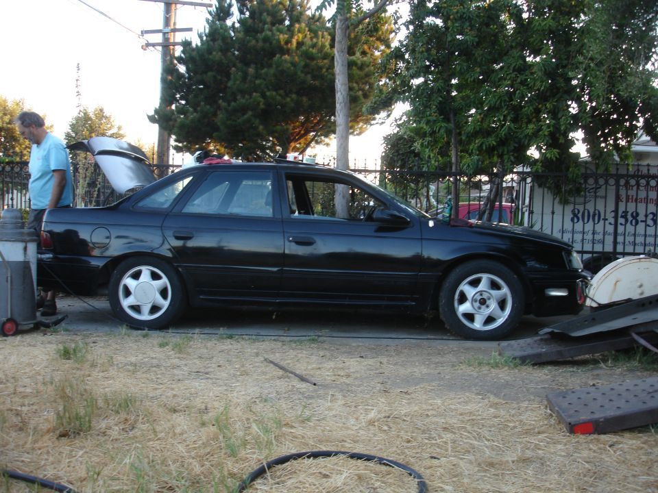 Black 1991 Ford Taurus sedan, side view