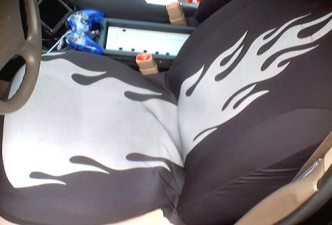 1999 Ford Taurus - Custom flame seat covers are visible in this car's interior, along with a video game controller.