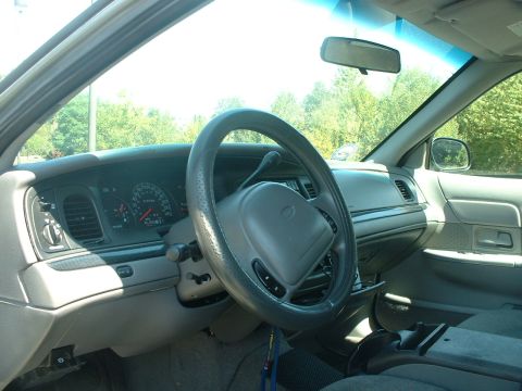 2000 Ford Crown Victoria - Interior view of a 2000 Ford Crown Victoria, highlighting the dashboard and steering wheel.