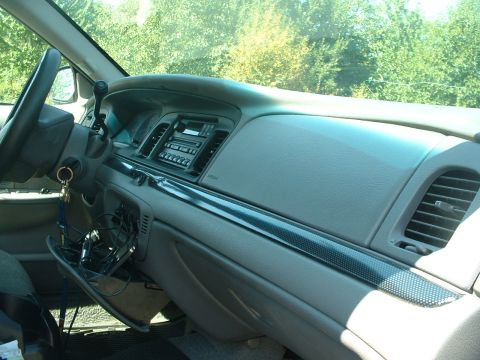 2000 Ford Crown Victoria - Interior view of a 2000 Ford Crown Victoria dashboard, revealing the driver's side controls and passenger side dashboard details.