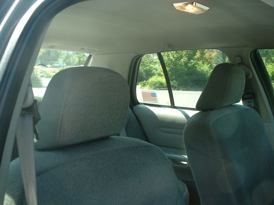 Interior shot of car seats and windows. American flag sticker on rear window