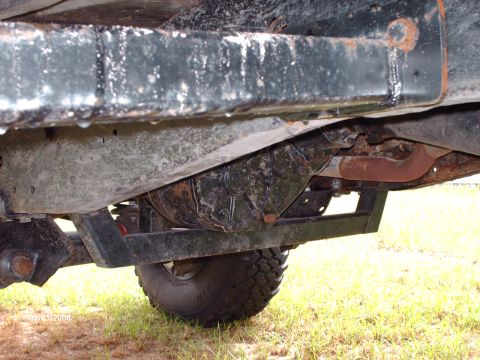 1982 Ford F-100 - The underside of a truck is visible, revealing the fuel tank and exhaust system components.