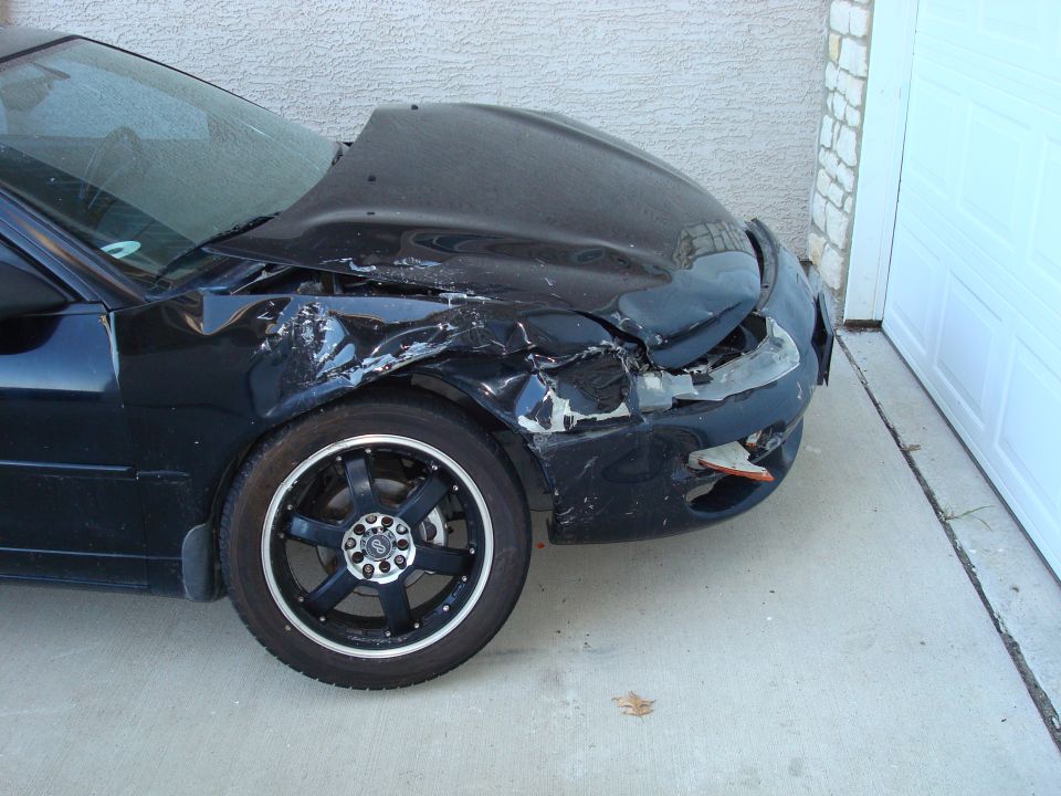 1998 Dodge Avenger front fender and hood severely damaged after an accident