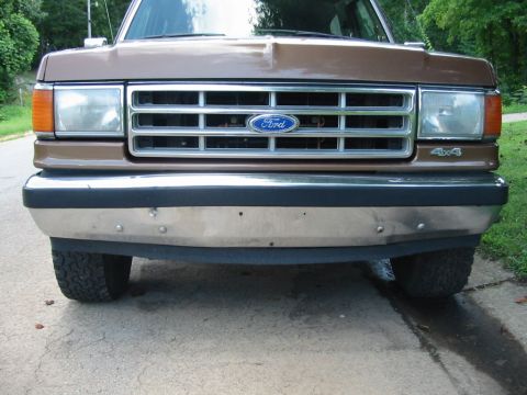 1988 Ford Bronco - Front view of a brown Ford Bronco showing its grille and bumper.
