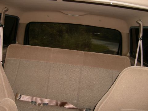 1992 Ford Bronco - The interior of a vehicle shows a rear bench seat and tinted windows, with the Supermotors.net logo in the corner.