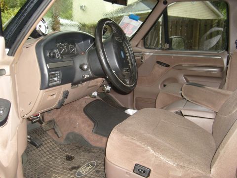 1992 Ford Bronco - Interior view of a 1992 Ford Bronco, the dashboard, steering wheel, and seating areas.