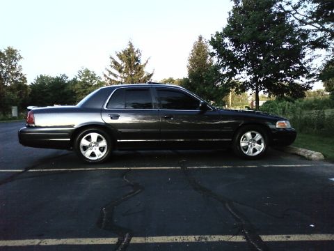 2004 Ford Crown Victoria - Side view of a 2004 Ford Crown Victoria Lx Sport parked outdoors.