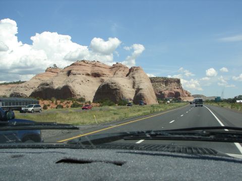 1992 Ford Taurus - View from inside a vehicle traveling on a highway, with prominent red rock formations and other cars visible.